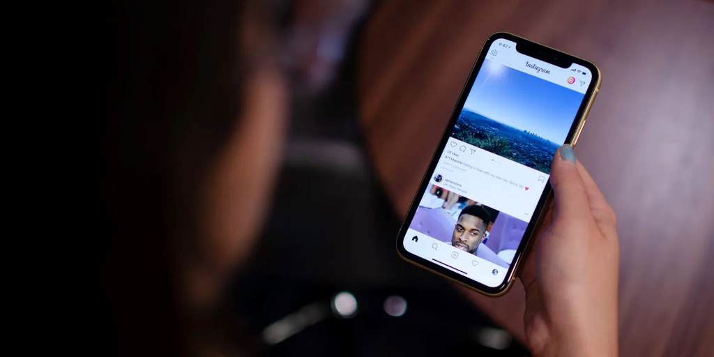 Person scrolling Instagram on phone during lunch break 