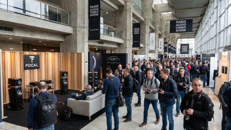 Visitors exploring hi-fi listening rooms at the Paris Audio Video Show inside Palais des Congrès